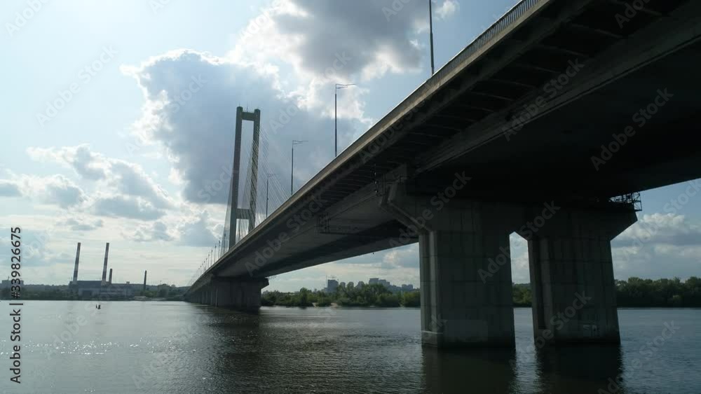 South bridge across the Dnieper in Kiev. Ukraine. Video from drone Traffic. The movement of cars and trains on the bridge. Metro. View under the bridge.