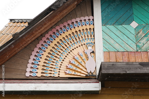 Detail of wooden rural house with carved windows, frames in Altai Krai, Siberia, Russia. Russian traditional national style in architecture. Siberian countryside photo