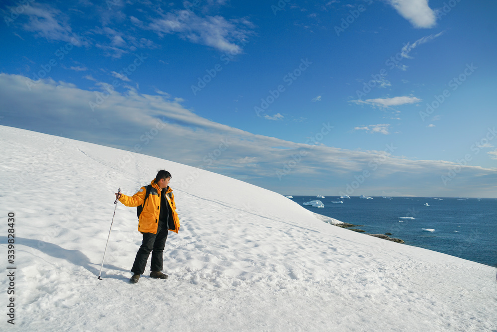 Man Standing on Ice Looking at Water