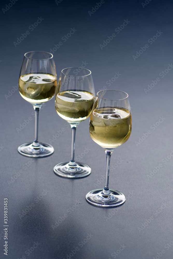 three glasses of fresh golden delicious riesling white wine in a line three glasses of fresh golden delicious riesling white wine in a line