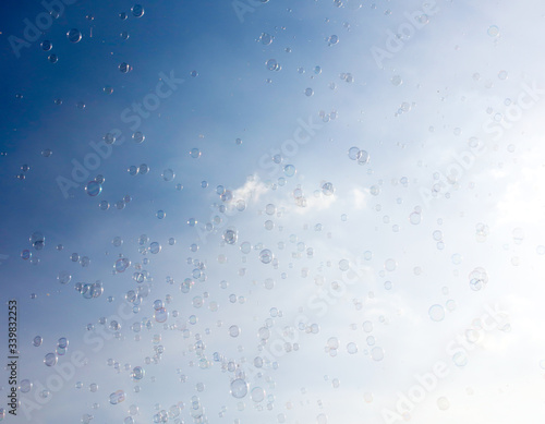 Soap bubbles fly in the blue sky