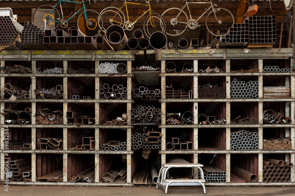Different styles and sizes of old recycled metal pipes and profiles construction materials