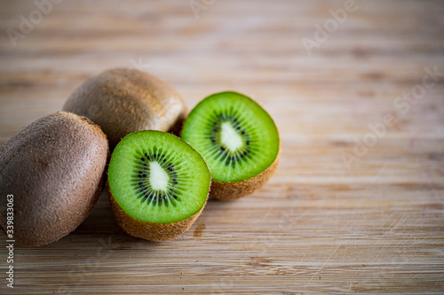 Fresh kiwifruit on wooden cutting board.