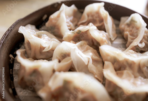 People eat Chinese manti with soy