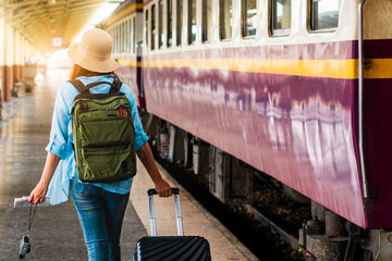 Solo woman backpacker traveler plan safety trip low cost budget summer holiday after coronavirus. Empty tourists on train railway platforms. Use bus train sustainable environmental friendly transport
