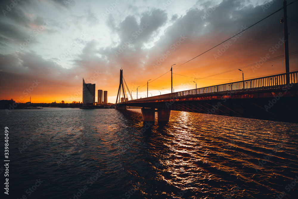 Vansu bridge in Riga cable-stayed bridge  crosses the Daugava river in susnet time