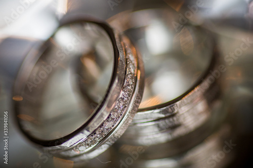 Close-up of two Wedding rings on a diamond shaped crystal or glass on a weddings day 