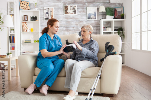 Female nurse showing elderly age woman