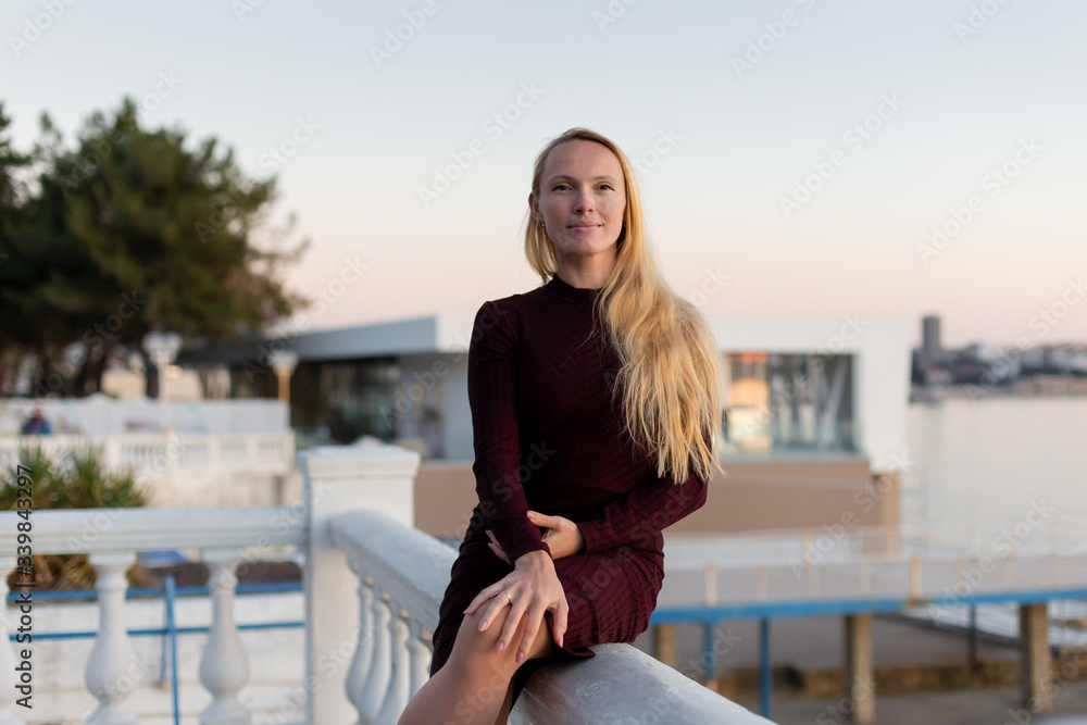 blonde model at the sea on sunset