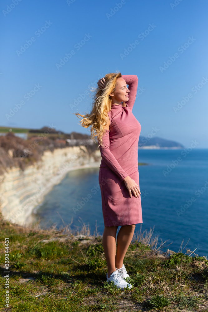 blonde model by the sea at the summer 