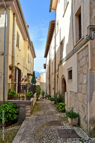 A narrow street between the old houses of a medieval village © Giambattista
