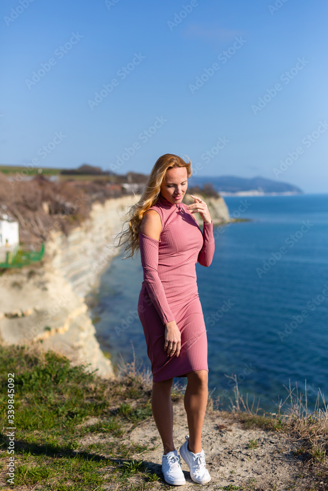 blonde model by the sea at the summer 
