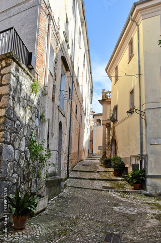 A narrow street between the old houses of a medieval village © Giambattista
