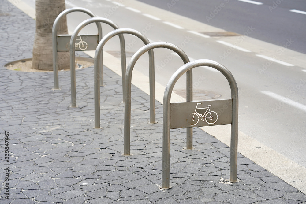 Empty bike parking. Parking space or spot for multiple bikes. place for Parking at the house or shop of bicycles or scooters, environmental transport in the city. Empty parking in city park. Empty bike parking. Parking space or spot for multiple bikes. place for Parking at the house or shop of bicycles or scooters, environmental transport in the city. Empty parking in city park.