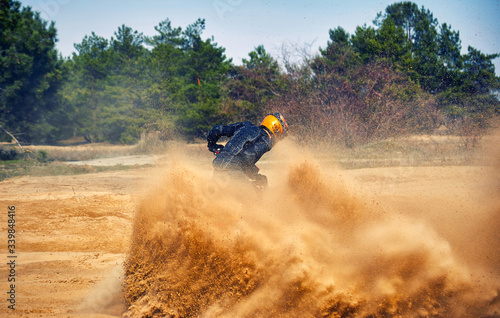 Racing in the sand on a four-wheel drive quad.