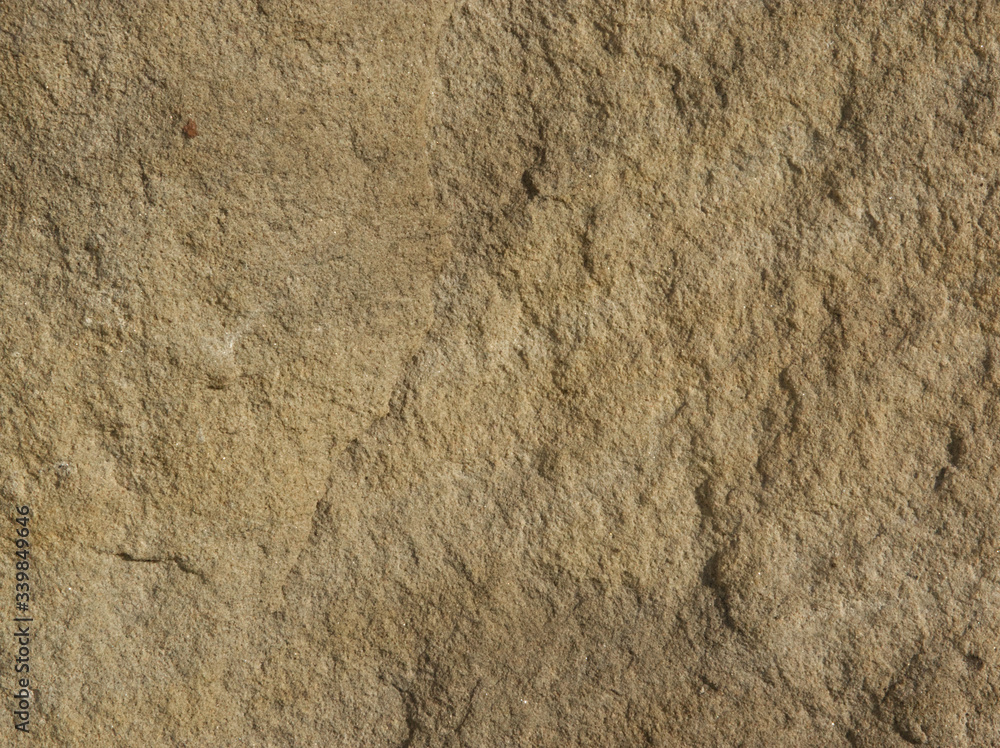 Orange stone texture picture with reliefs at sunset Orange stone texture picture with reliefs at sunset