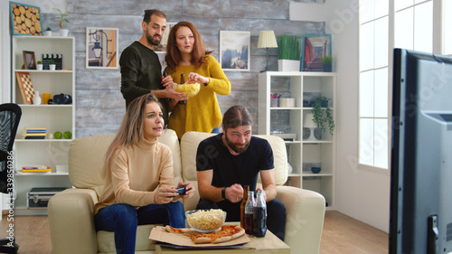 Cheerful caucasian friends playing video games