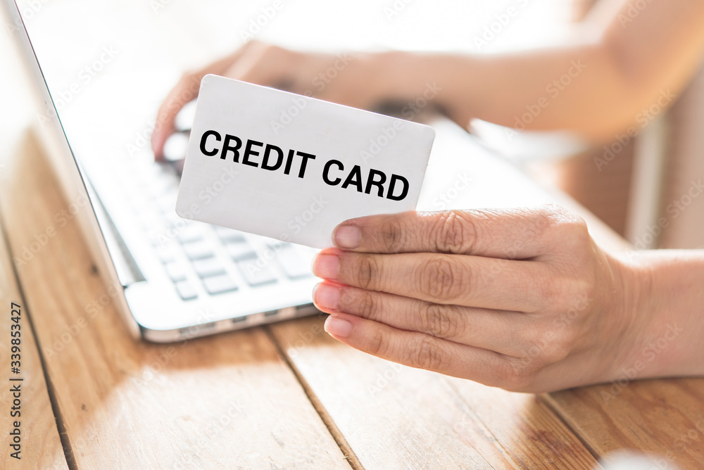 Top view of man using credit card for online shopping Top view of man using credit card for online shopping