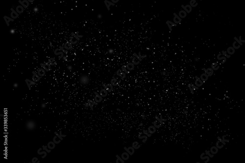 Dust particle on black abstract background. White dust element bokeh pattern flying in a dark