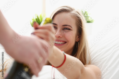 young blond beautiful woman take bottle of wine unhealthy way of life concept