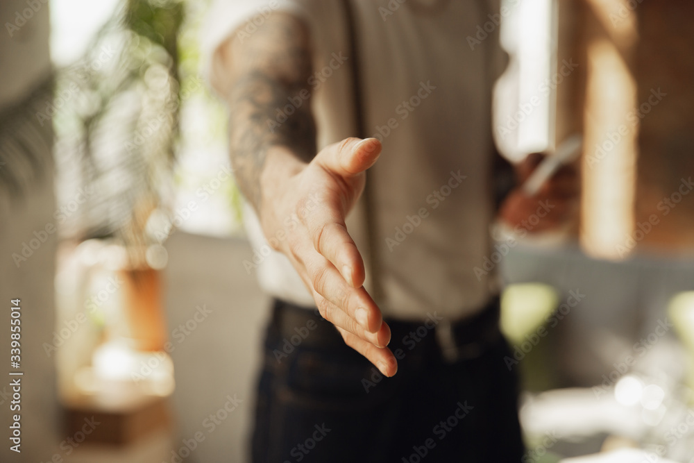Close up of male hand greeting, welcoming somebody. Education, freelance, business and communication concept. Caucasian male model indoors inviting, showing.