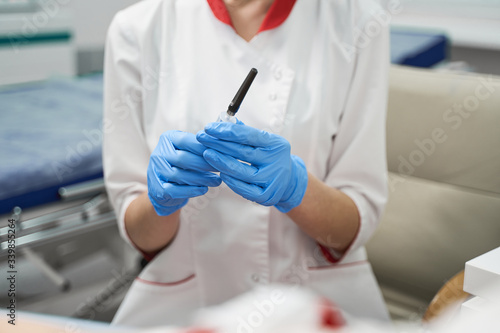 Focused photo on female hand that holding test tube