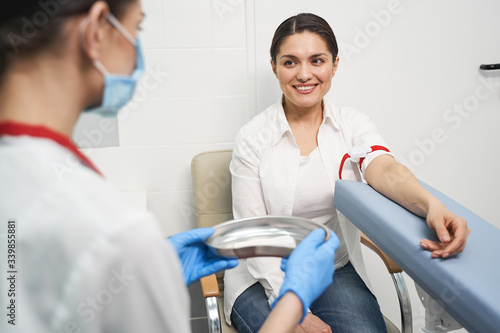 Delighted brunette girl looking at her doctor