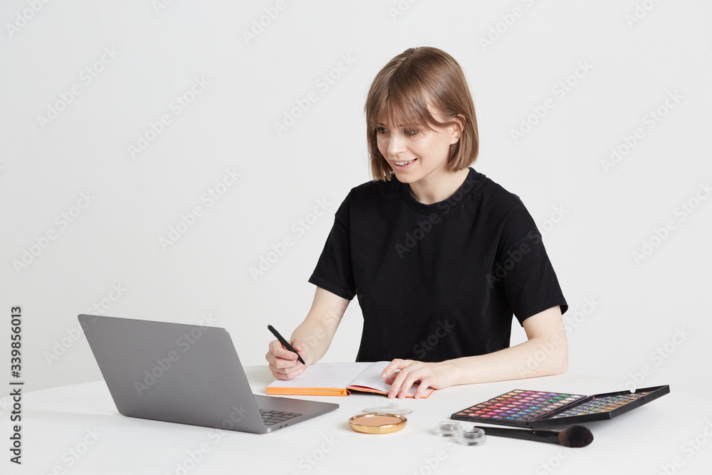 A nice young girl learns the art of makeup remotely, using a laptop and video call, over the Internet, staying at home. A nice young girl learns the art of makeup remotely, using a laptop and video call, over the Internet, staying at home.