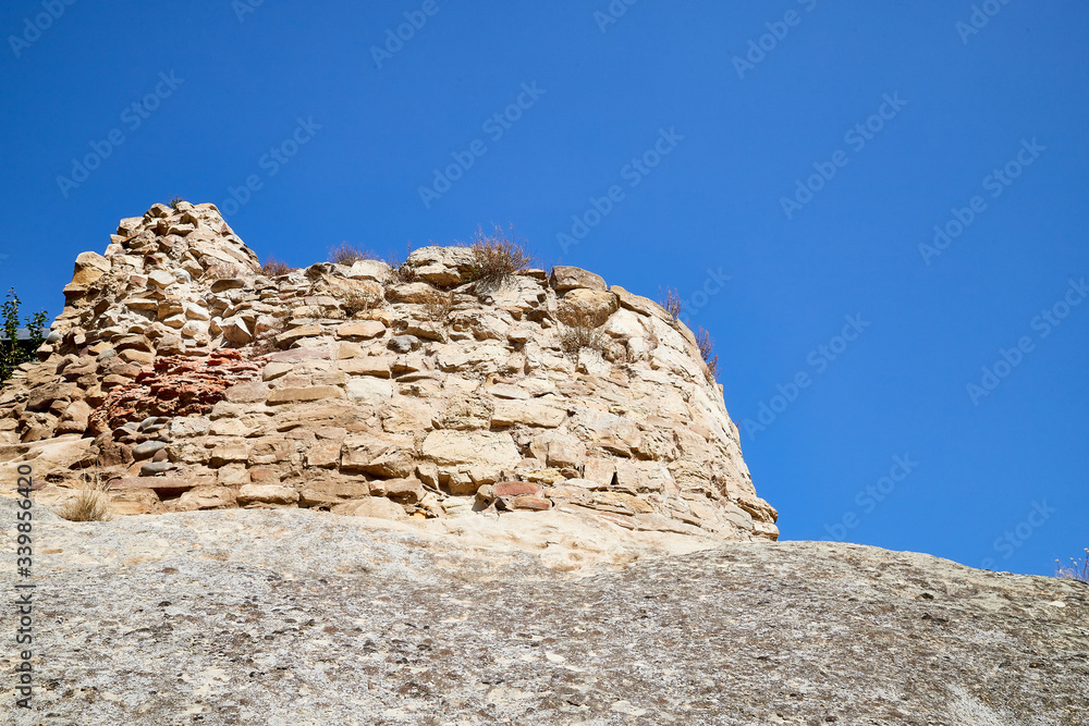 View of Antique cave city with old houses, rocks and grey stones in a sunny day with blue sky. Uplistsikhe city, Georgia, Europe View of Antique cave city with old houses, rocks and grey stones in a sunny day with blue sky. Uplistsikhe city, Georgia, Europe