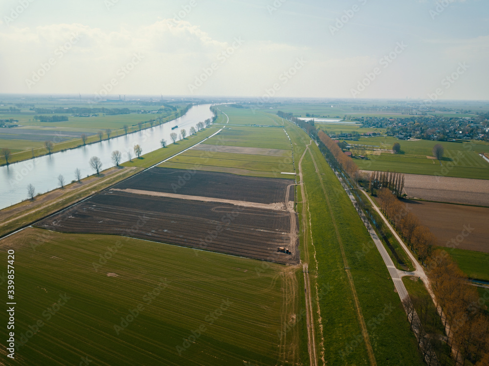Beautiful aerial drone shot over the flat landscape of the Netherlands, Europe. 