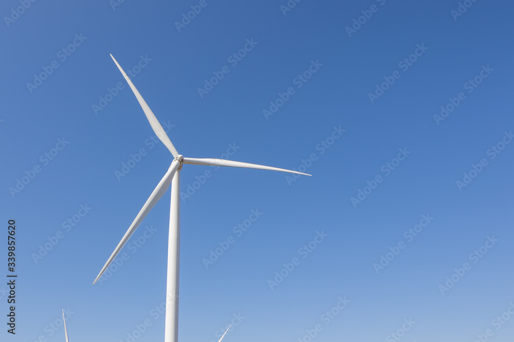 Beautiful green meadow with Wind turbines and sky generating electricity in Thailand Beautiful green meadow with Wind turbines and sky generating electricity in Thailand