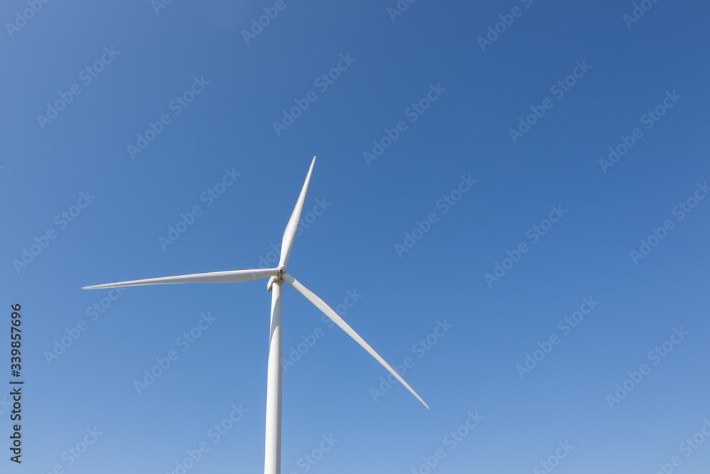 Beautiful green meadow with Wind turbines and sky generating electricity in Thailand Beautiful green meadow with Wind turbines and sky generating electricity in Thailand