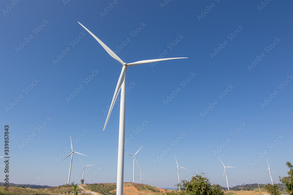 Beautiful green meadow with Wind turbines and sky generating electricity in Thailand Beautiful green meadow with Wind turbines and sky generating electricity in Thailand