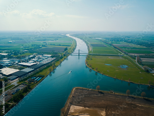 Aerial drone shot over the canal with bridge and road in the Netherlands