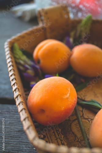 appricot in a basket on wooden table photo