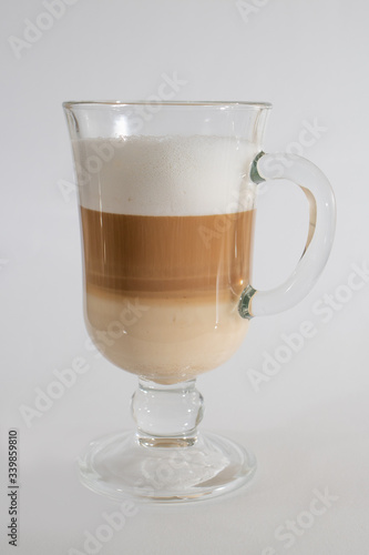 clear glass cup with latte on a white background