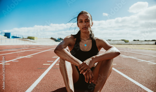 Professional athlete relaxing on the track after training sessio photo