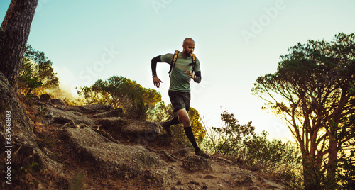 Fototapeta Naklejka Na Ścianę i Meble -  Runner running through rocky mountain path