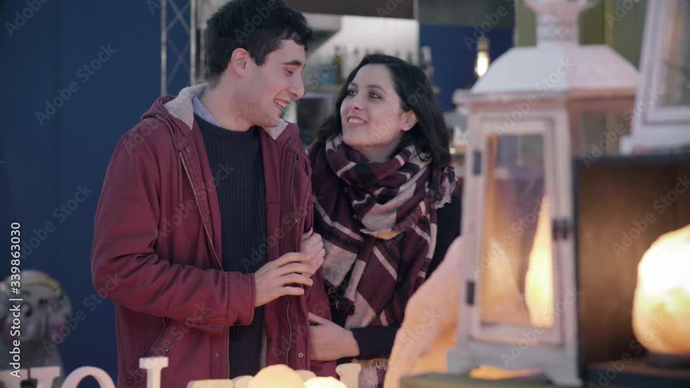 Christmas time - young happy couple in a lamp store buying the gifts Christmas time - young happy couple in a lamp store buying the gifts