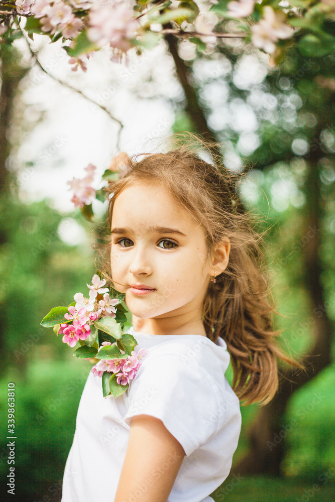 Girl spring branches of a flowering Apple tree, beauty and youth, portrait in flowering branches, trees, walk in the Park, rest Girl spring branches of a flowering Apple tree, beauty and youth, portrait in flowering branches, trees, walk in the Park, rest