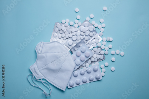 Protective mask on a background of white pills
