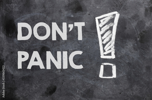 DON'T PANIC text on a black chalk board.