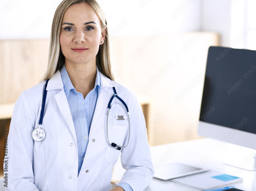 Woman doctor standing in hospital office. Physician at work, life portrait. Medicine and health care concept Woman doctor standing in hospital office. Physician at work, life portrait. Medicine and health care concept