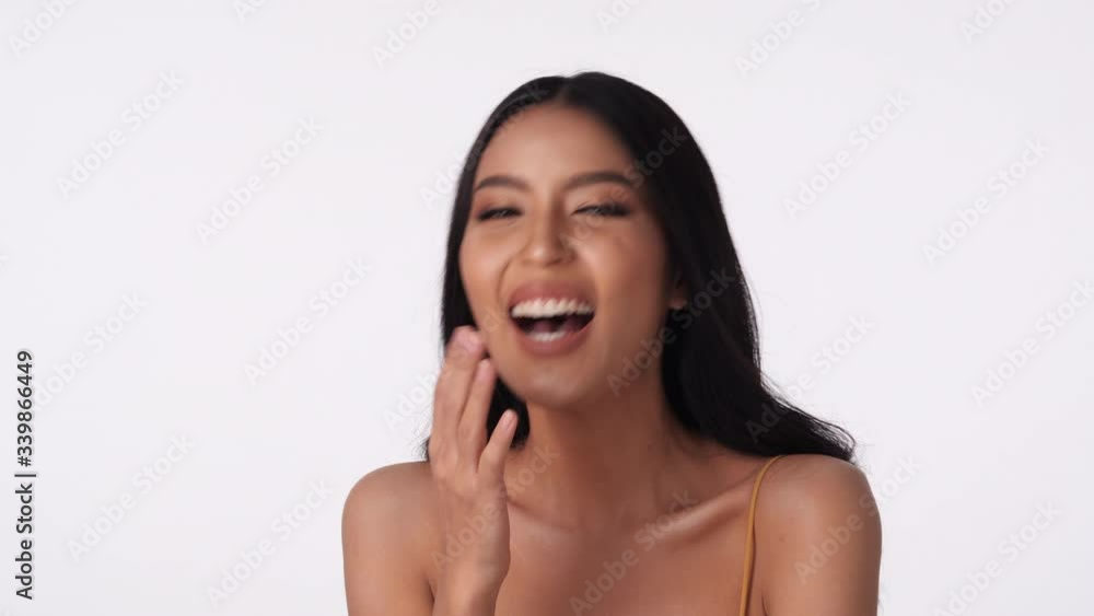 Portrait of beautiful asian woman smile and laugh joyfully on isolated white background. Concept of beauty, cosmetic, healthcare, fashion and skincare. 4K UHD. Portrait of beautiful asian woman smile and laugh joyfully on isolated white background. Concept of beauty, cosmetic, healthcare, fashion and skincare. 4K UHD.