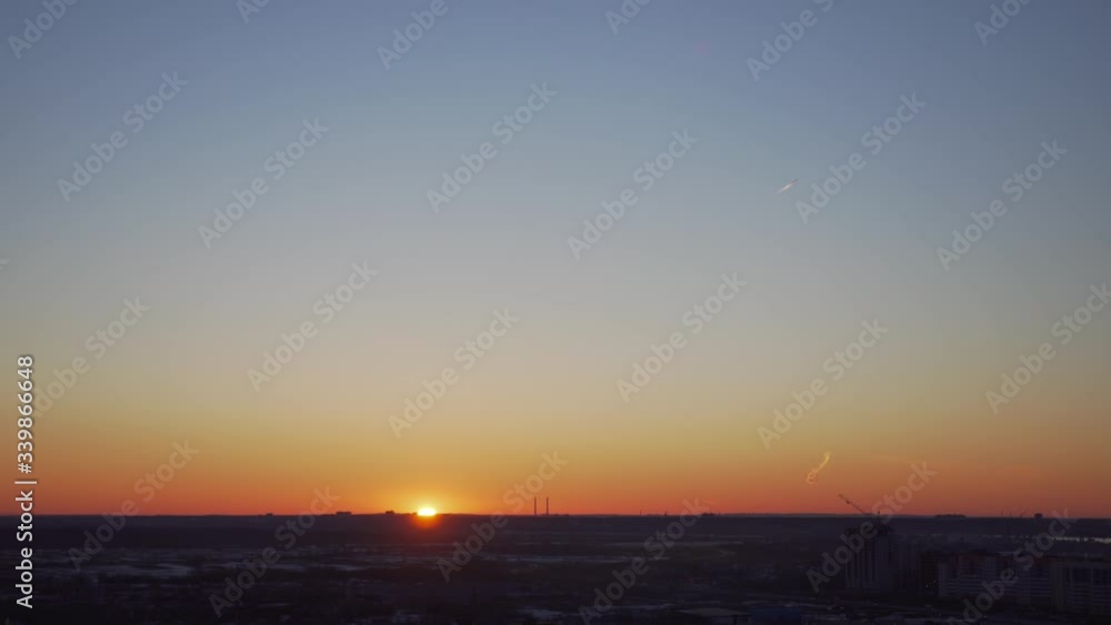 bright sun sets over the horizon in an industrial city bright sun sets over the horizon in an industrial city
