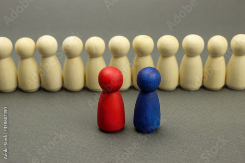 Wooden figures of people. Two leaders in front of the team, business concept