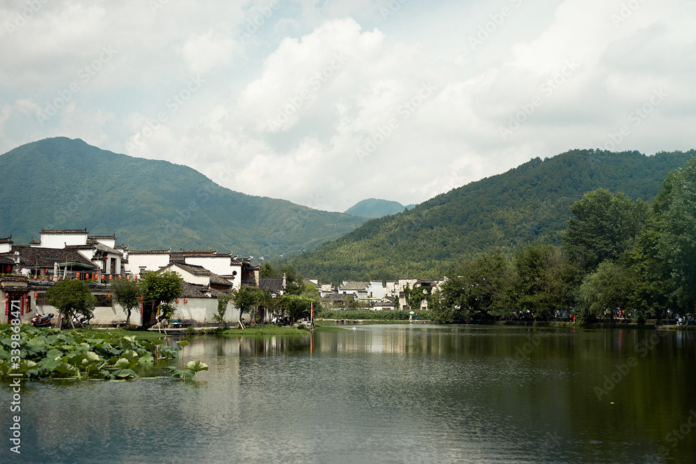 Landscape view with ancient village, mountains and river 