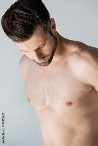 muscular and shirtless man standing isolated on grey