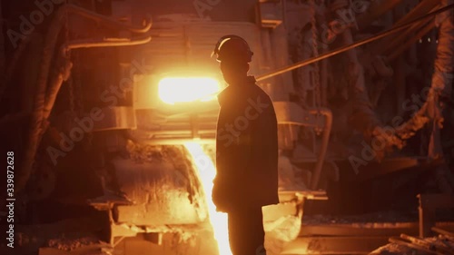 Hard work in a foundry. Metal smelting furnace in steel mill. Molten metal pouring, metallurgy, steel casting foundry. Steel manufacturing