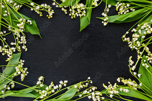 Beautiful Lily of the Valley Flowers with leaves frame.